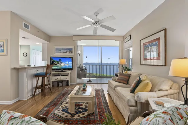 a living room with furniture a flat screen tv and a window