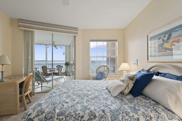 a bedroom with a large bed and windows