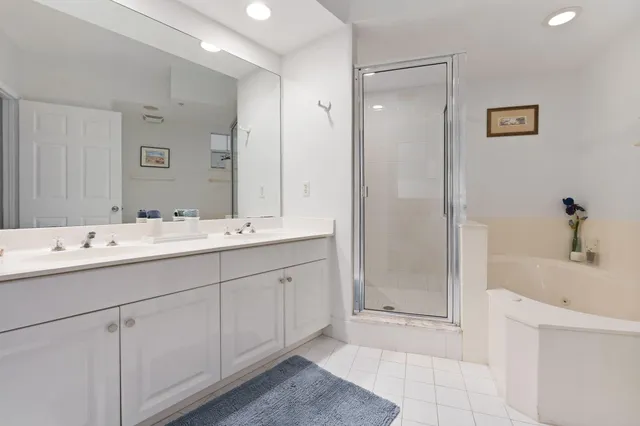 a bathroom with a sink tub and a mirror