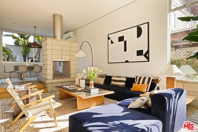 a outdoor living space with furniture flowerpot and a fireplace