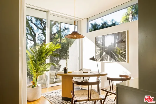 a view of a dining room with furniture and a window