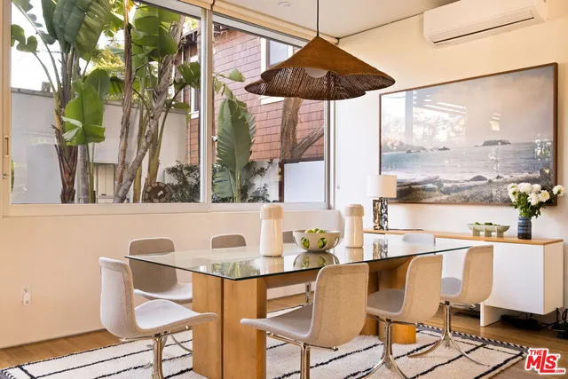 a dining room with furniture a chandelier and wooden floor