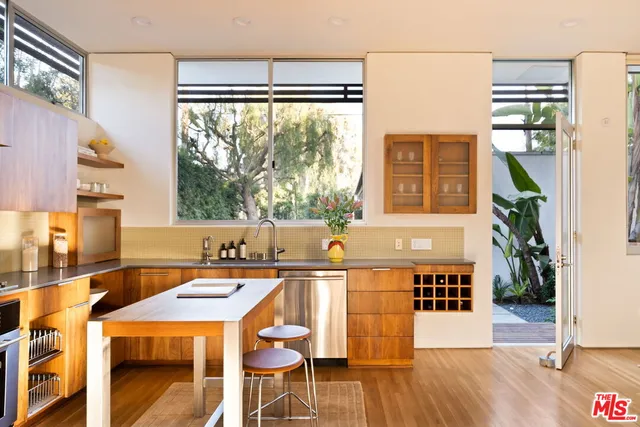 a dining table chairs and a large window in a room