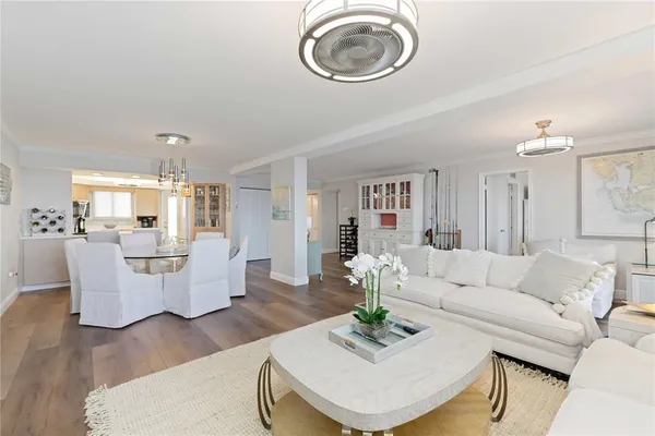 a living room with furniture and kitchen view