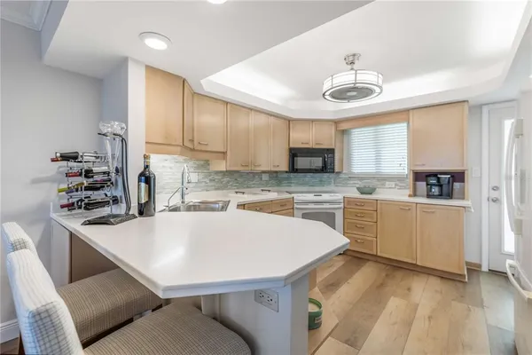 a kitchen with stainless steel appliances granite countertop a sink a stove and cabinets