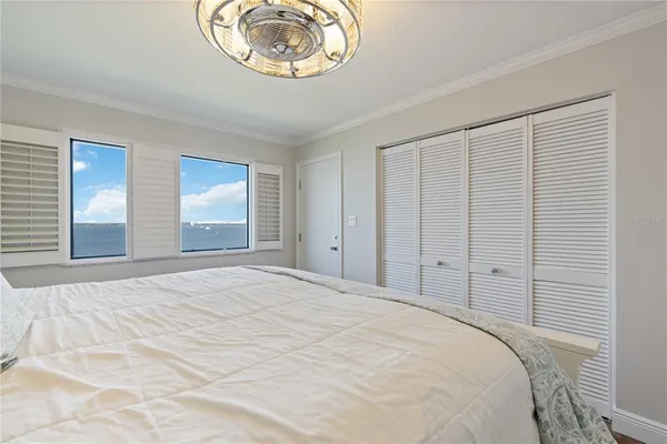 a bedroom with a bed and a chandelier