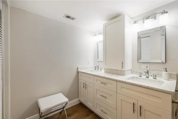 a bathroom with a granite countertop sink mirror and double