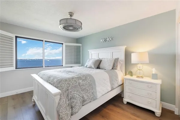 a bedroom with a bed and a television