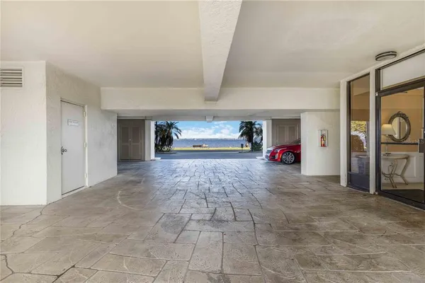 a living room with furniture a flat screen tv and a refrigerator
