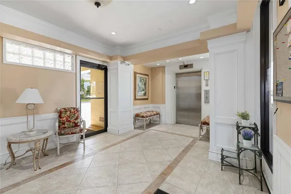 a view of a hallway with wooden floor and closet