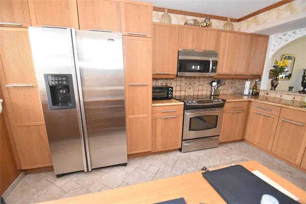 a kitchen with a refrigerator sink and microwave