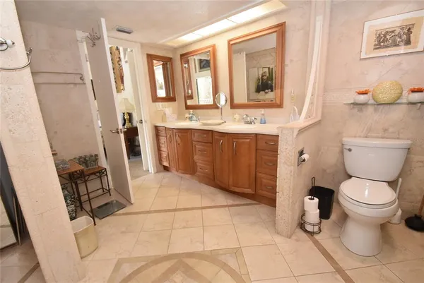 a bathroom with a sink a toilet and a mirror