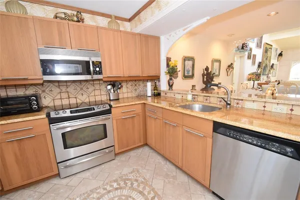a kitchen with a sink stove and microwave