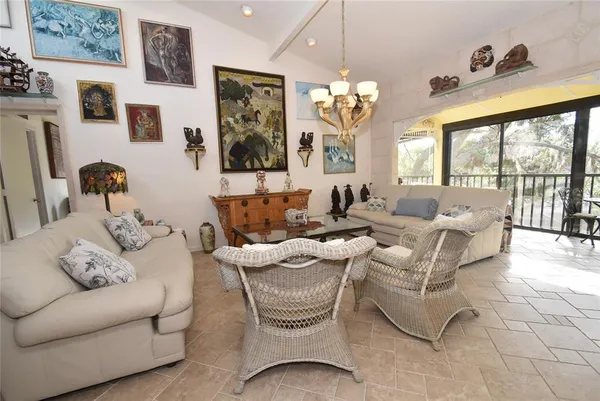 a living room with furniture chandelier and a chandelier