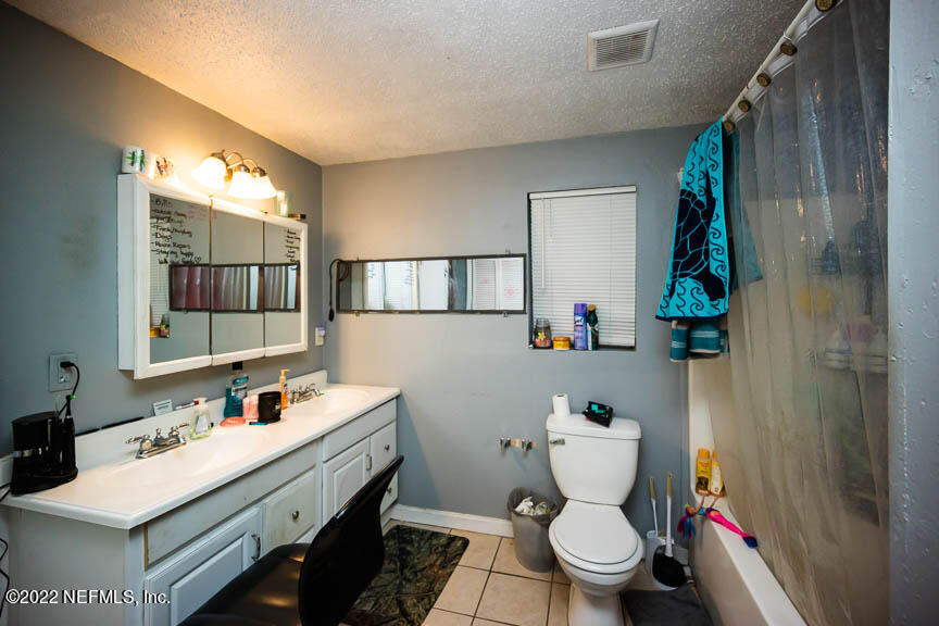 6836 Morgana Road North Jacksonville, FL 32211 - Photo 11 of 15 a bathroom with a sink mirror vanity and toilet