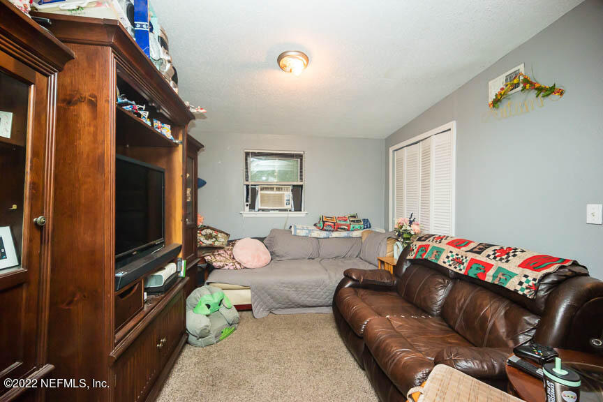 6836 Morgana Road North Jacksonville, FL 32211 - Photo 5 of 15 a living room with furniture and a flat screen tv