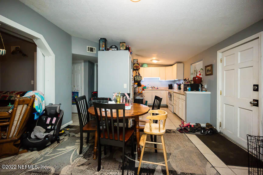 6836 Morgana Road North Jacksonville, FL 32211 - Photo 6 of 15 a dining room with furniture and wooden floor
