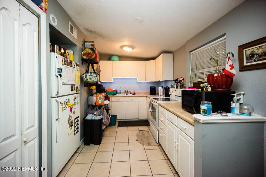 6836 Morgana Road North Jacksonville, FL 32211 - Photo 8 of 15 a kitchen with a refrigerator and a stove