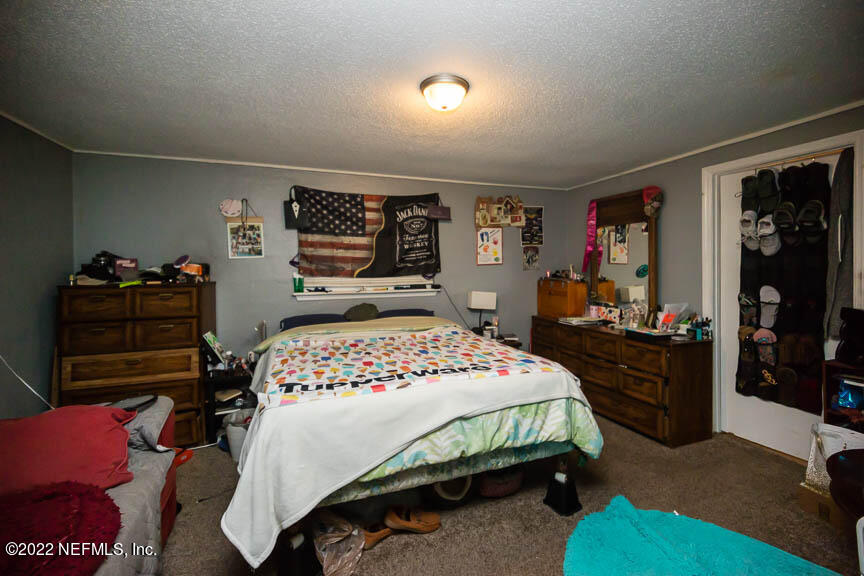 6836 Morgana Road North Jacksonville, FL 32211 - Photo 10 of 15 a bedroom with a bed and furniture