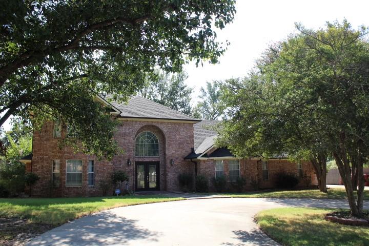2020 Arbor Bend Road Bonham, TX 75418 - Photo 1 of 19 Brick exterior with a gabled roof and arched window above double entry doors