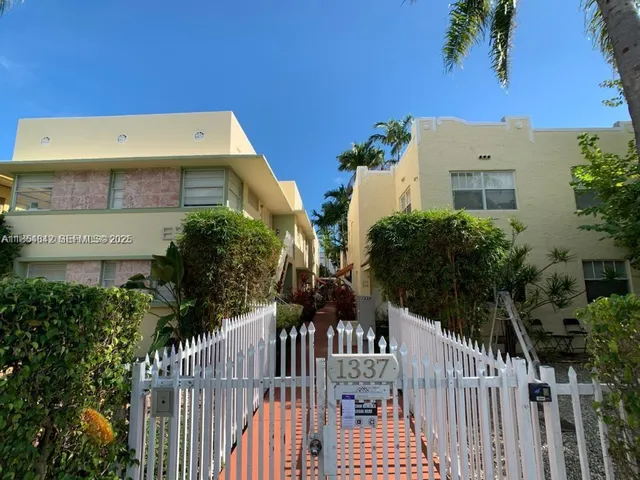 a view of a house with wooden fence