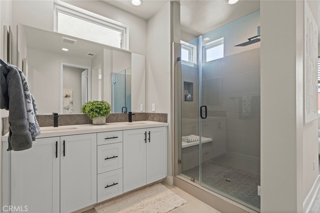359 Novel Irvine, CA 92618 - Photo 28 of 43 a bathroom with a shower sink and mirror