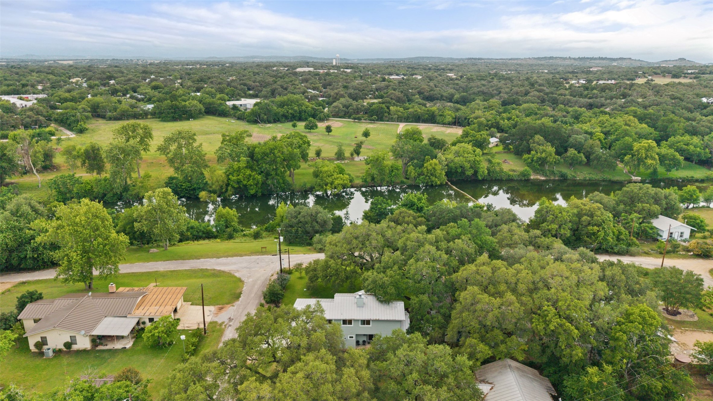 701 River Road Blanco, TX 78606 - Photo 38 of 38 an aerial view of residential houses with outdoor space and trees