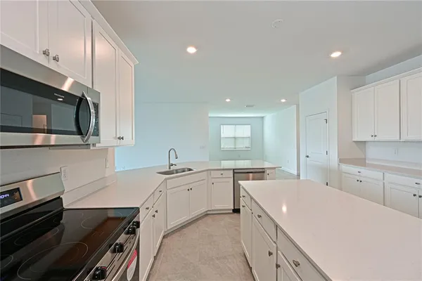 a kitchen with a sink stove and microwave
