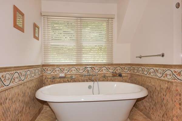 69 Wayside Road, Unit 69 Concord, MA 01742 - Photo 11 of 22 a white bath tub sitting in a bathroom next to a window