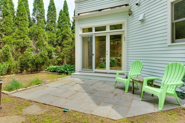 69 Wayside Road, Unit 69 Concord, MA 01742 - Photo 17 of 22 a view of a chair and table in backyard of the house