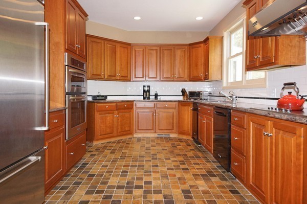 69 Wayside Road, Unit 69 Concord, MA 01742 - Photo 4 of 22 a kitchen with stainless steel appliances granite countertop a sink stove refrigerator and cabinets