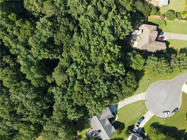 an aerial view of a house with a yard and a garden