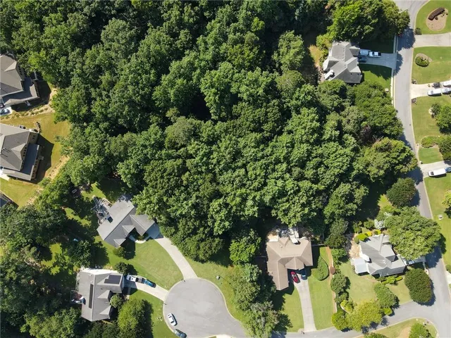 an aerial view of a house with a yard swimming pool and outdoor seating