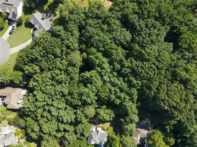 an aerial view of a house with a yard and outdoor seating