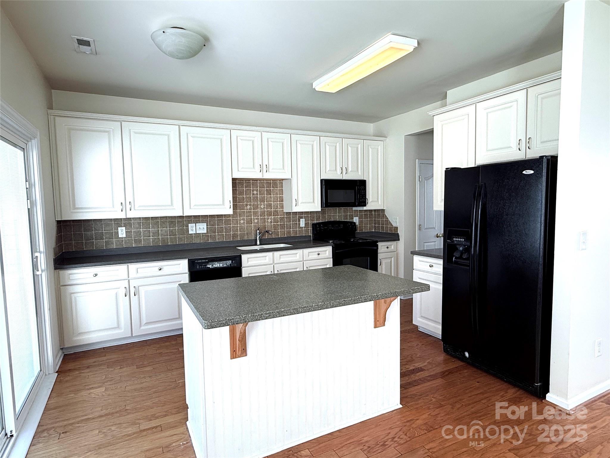 7549 Bluff Point Lane Denver, NC 28037 - Photo 8 of 18 a kitchen with stainless steel appliances granite countertop a refrigerator a stove a sink and a microwave