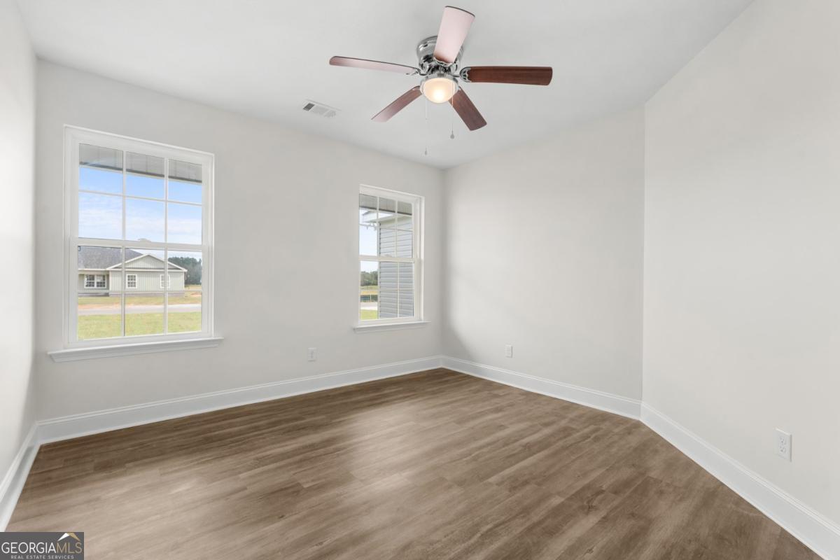 909 Ryegrass Road, Unit 81 Statesboro, GA 30458 - Photo 15 of 23 wooden floor in an empty room with a window