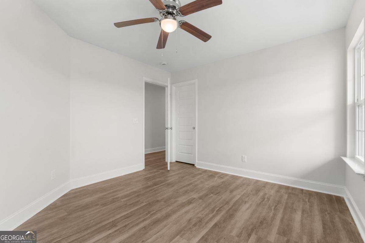 909 Ryegrass Road, Unit 81 Statesboro, GA 30458 - Photo 16 of 23 an empty room with wooden floor and a ceiling fan