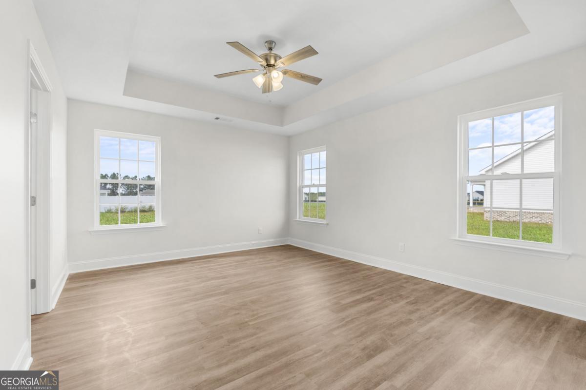 909 Ryegrass Road, Unit 81 Statesboro, GA 30458 - Photo 4 of 23 a view of an empty room with a window and wooden floor