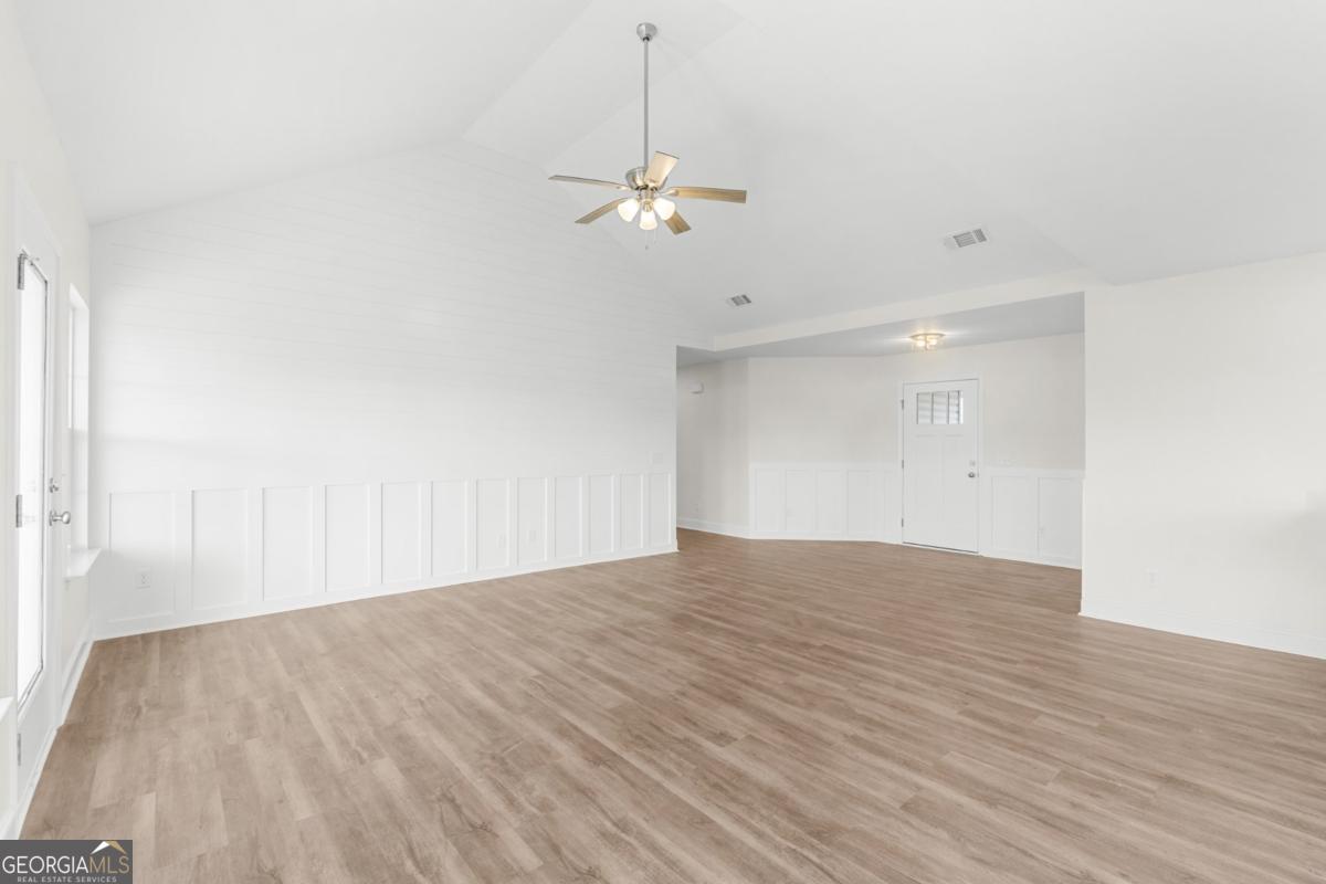 909 Ryegrass Road, Unit 81 Statesboro, GA 30458 - Photo 6 of 23 a view of a room with wooden floor and ceiling fan