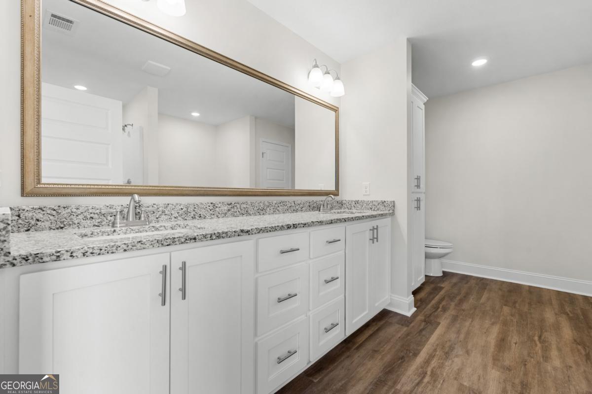 909 Ryegrass Road, Unit 81 Statesboro, GA 30458 - Photo 10 of 23 a bathroom with a granite countertop sink and a mirror