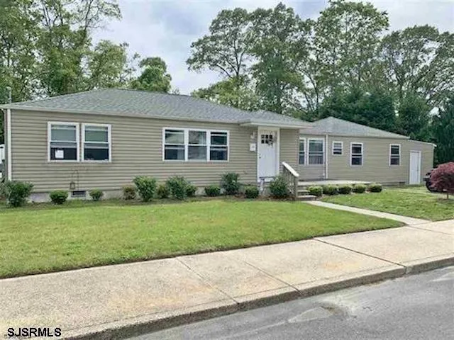 front view of a house next to a yard