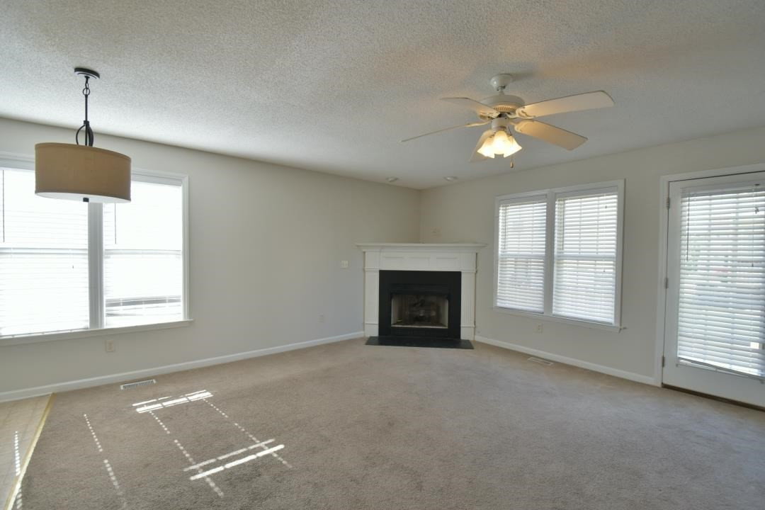 4408 Windsock Lane Raleigh, NC 27616 - Photo 13 of 22 Living room was updated to linoleum flooring linoleum flooring