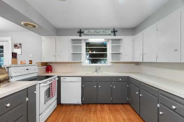 a kitchen with a sink stove and cabinets