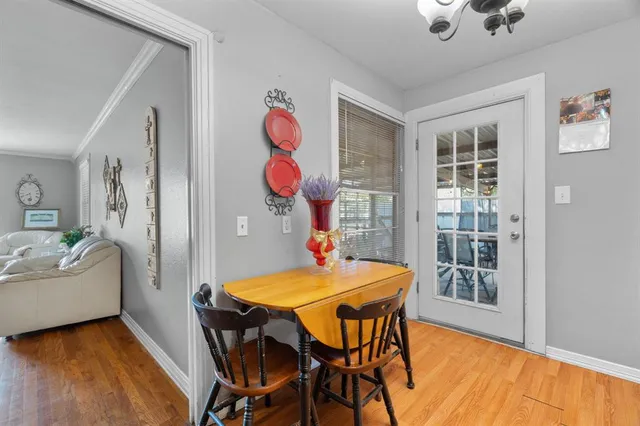a dining room with furniture and wooden floor