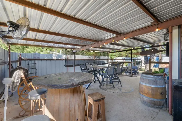 a backyard of a house with table and chairs