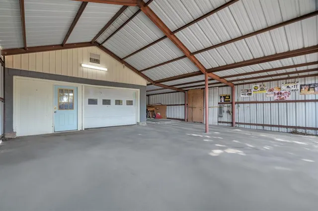 a view of a house with a yard and wooden fence