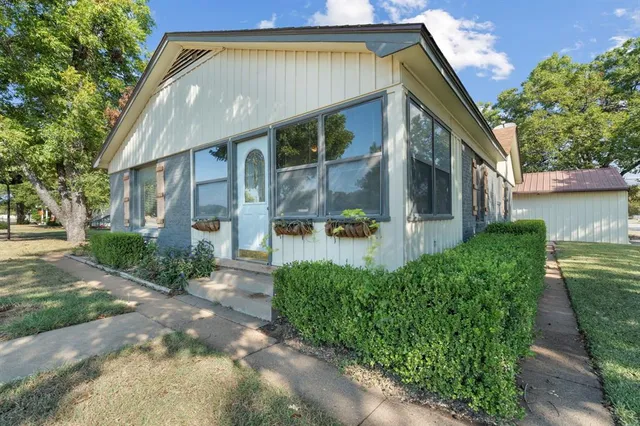 a front view of a house with garden