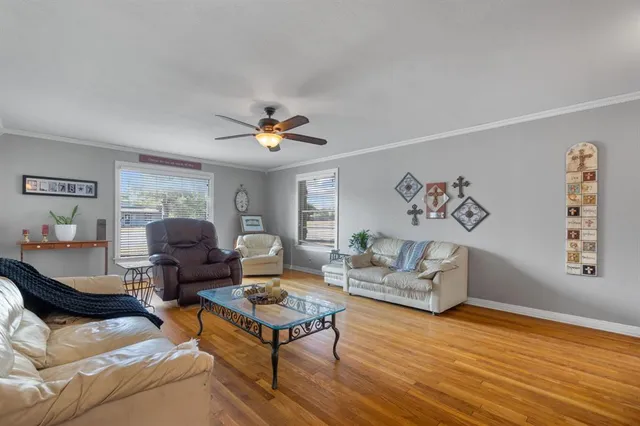 a living room with furniture and wooden floor