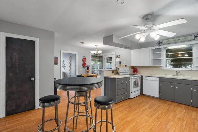 a kitchen with stainless steel appliances kitchen island granite countertop a sink and cabinets