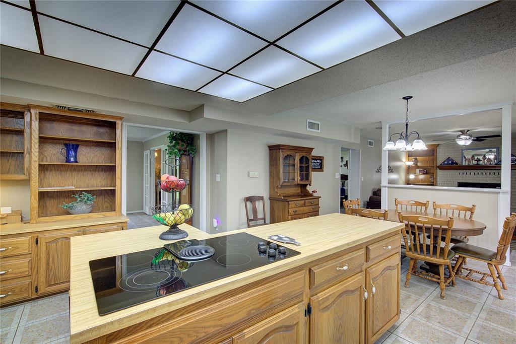 753 County Rd SW 3110 Mount Vernon, TX 75457 - Photo 11 of 40 Kitchen has large island with cooktop, desk area with extra storage, breakfast area